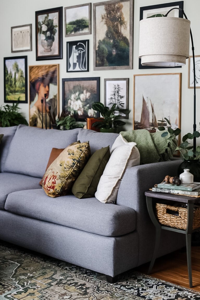 living room with large vintage gallery wall, gray sectional, arc floor lamp