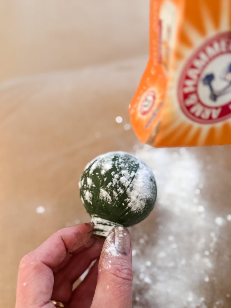 sprinkling baking soda onto wet paint