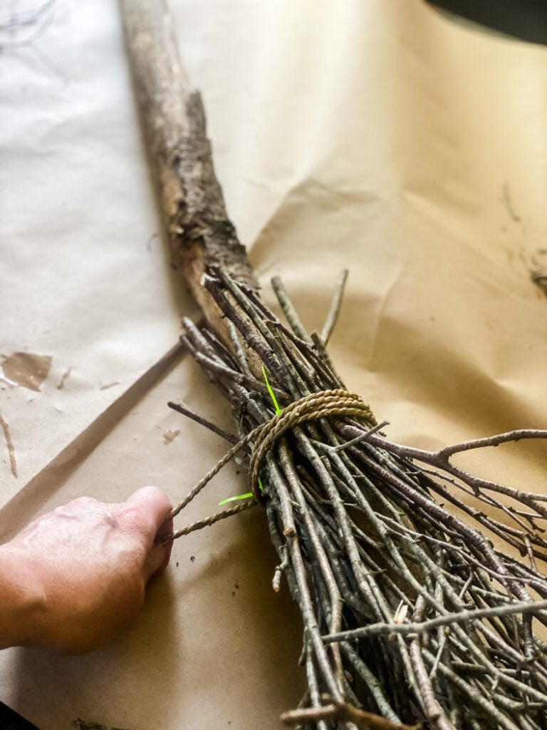 wrapping cording around witch broom.