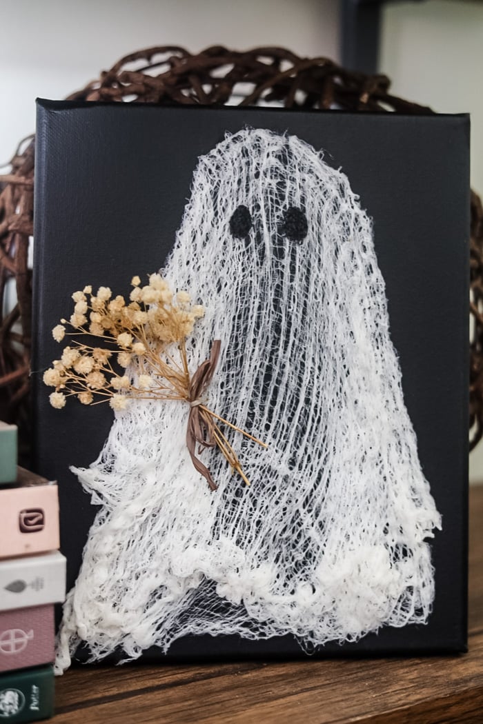 floating ghost canvas diy made with cheesecloth on a black canvas