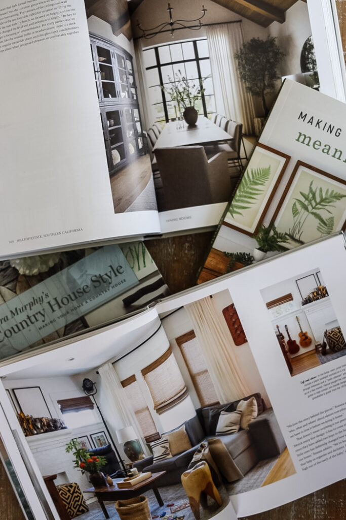 4 home decor books on a table with open pages