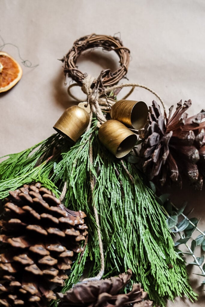 closeup of top of a winter swag with greenery and pinecones