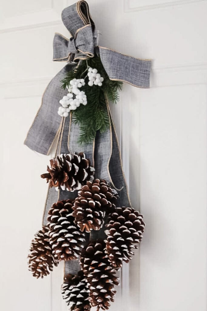 pinecone door swag with gray ribbon