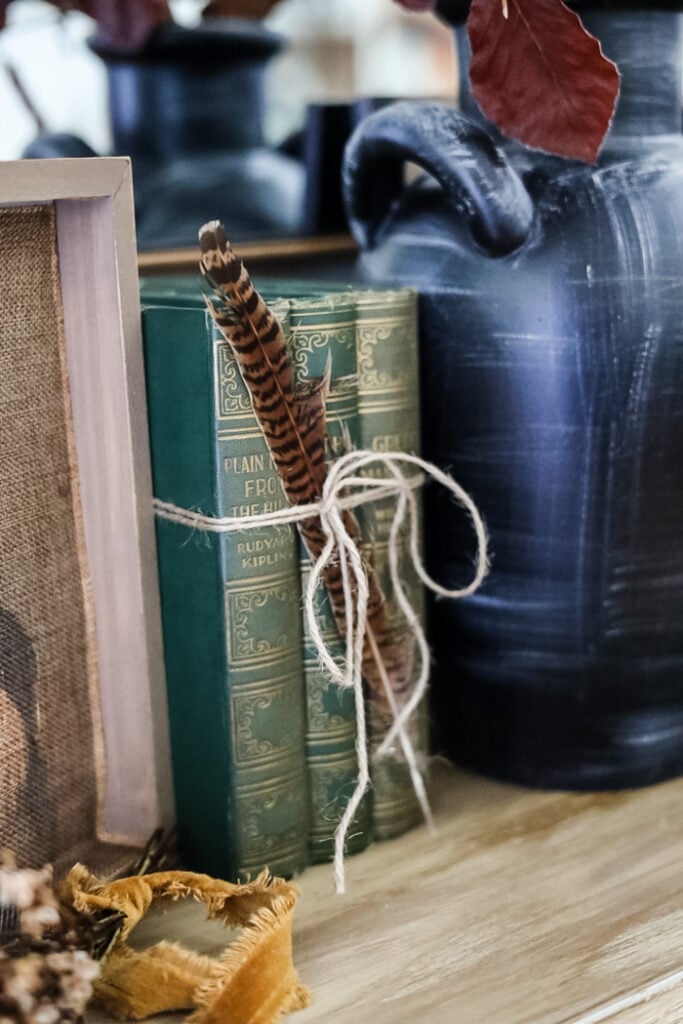 vintage books tied with jute and a feather