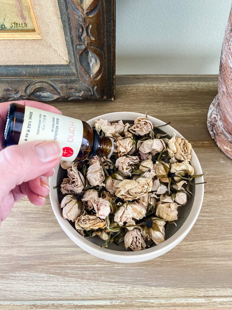making potpourri with rose buds and rose oil