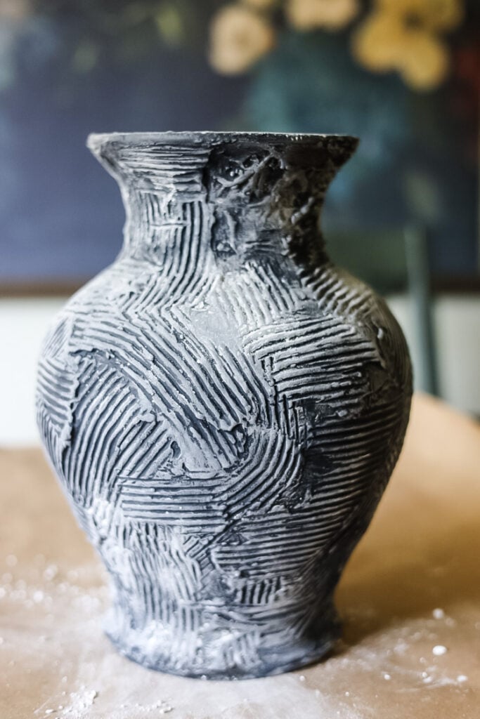 a vase with chalk dust covering it.