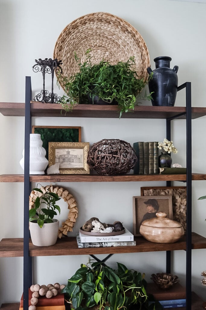 tall bookcase with a variety of home decor items