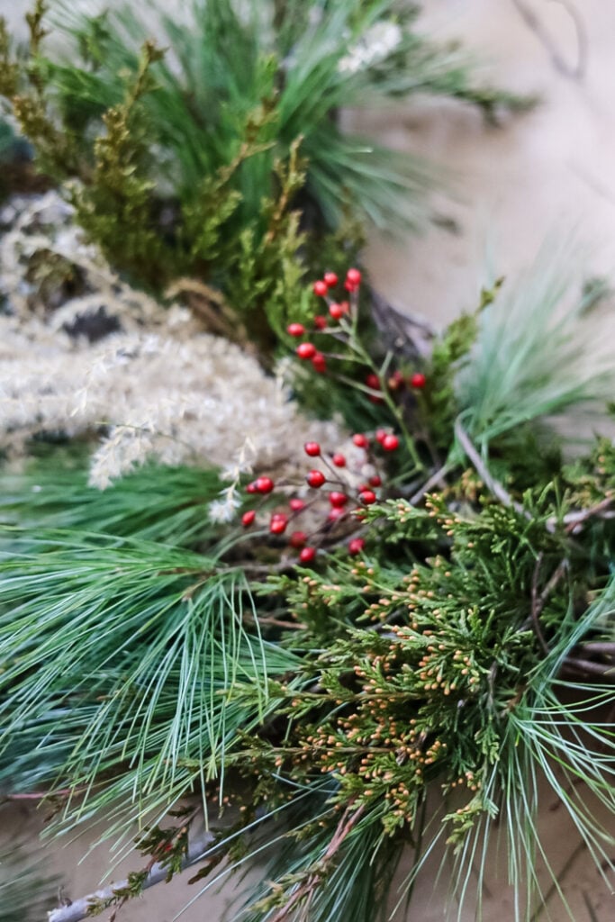 closeup of a winter wreath with greenry and berries